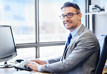 Canvas Print - Face, businessman and typing in office for corporate company with web, planning and advice. Tech, executive and portrait of male consultant in workplace with suit, internet and expertise for client