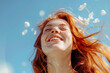 A joyful ginger hair woman smiles broadly, her face framed by floating pink petals against a clear blue sky, epitomizing delight and freedom. hopecore concept.AI Generated