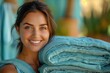 with warm smile, the woman housekeeper holds a stack of freshly laundered bed linens 