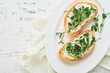Toast or sandwich with cream cheese and micro greens peas and sunflower. Concept healthy food or snack. Flat lay, copy space.