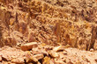 Dead Sea coastline of Jordan side. Cliffs consisting of multi-colored huge stones close-up. Nature concept for design.