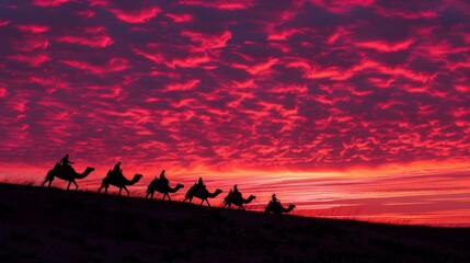 Wall Mural - Beneath the crimson hues of the evening sky, camels and their cameleers navigate the desert, a timeless tableau of endurance and perseverance.