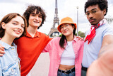 Fototapeta Londyn - Multiethnic group of young happy friends visiting Paris and Eiffel Tower