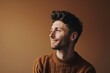 © Loli - Portrait of a handsome young man in a sweater on a brown background