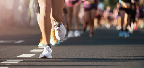 Poster - Marathon running in the light of morning. People feet on city road