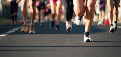 Poster - Marathon running in the light of morning. People feet on city road