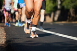 Fototapeta  - Marathon running race, people feet on city road