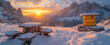 Snowy alpine retreat at sunrise with warm glowing light