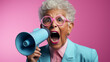 portrait of a senior woman screaming with a megaphone over a color background