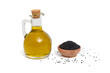 Olej z czarnuszki, butelka z olejem i miska z nasionami na białym tle
