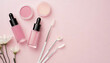 © Loliruri - Top view of beauty blenders pink eye patches lip gloss glass dropper bottle on pink background with copy space