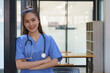 Asian female doctor with stethoscope and standing with arms crossed in hospital, Health care and medicine concept.