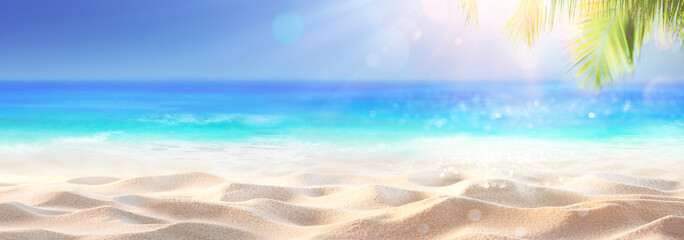 Wall Mural - tropical sand with blue sea and palm leaves - beach summer defocused background with glittering of s