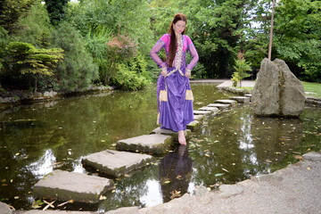 Beautiful colorful bollywood woman with colorful costume portrait at outdoor park. 