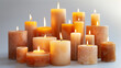 Group of lit candles in various sizes, with a warm glow, on a gentle background.