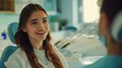 © ELIJA - A young female dentist is talking to a patient sitting in a dentist chair in a bright dental clinic