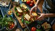 Overhead shot of a person meticulously cutting a sandwich on a wooden cutting board in a well-lit kitchen