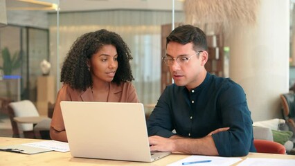 Aufkleber - Diverse professional workers team talking on financial technology or marketing data using laptop in office. Two busy business people man and woman working on computer discussing online project at work