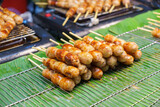 Fototapeta Miasta - Pork and rice sausage or fermented hot dog northeastern isan thai style hanging in hawker stall for sale