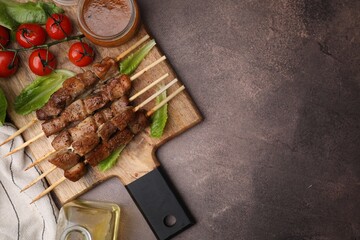 Wall Mural - Tasty cooked marinated meat served with sauce and tomatoes on grey table, flat lay. Space for text