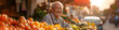 Senior man selling vegetables in farmer market. Counter with variety of organic vegetable. Natural bio products, homegrown eco fruits and vegetables. Local farmers market