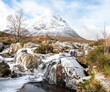 Partly frozen Waterfall on the River Coupall with Buachaille Etive Mor and Stob Deargin the background,  Glen Coe, Highlands, Scotland