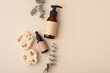 Eco-friendly skincare accessories concept with loofah sponges, cosmetic glass bottles and eucalyptus