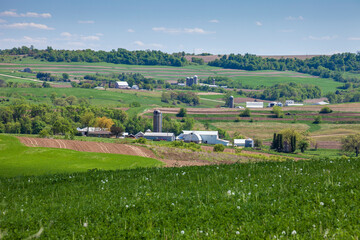 Wall Mural - Farms and fields on rolling hills in the Iowa countryside during spring