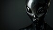 Portrait of a black alien on a black background with copy space.
