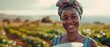 Black woman in a greenfield with a beautiful smile, plastic container-landscape image of the woman wearing a head scarf