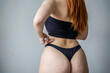 Empowered redhead embracing body positivity.  A candid moment reflecting body confidence and the beauty of realness in a personal space. A celebration of natural beauty and self-acceptance.
