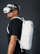 Portrait of man wearing augmented VR goggles with white backpack.
