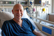 During his illness for cancer, bald, mature man smiles at hospital bed AI Generative