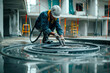 Worker use rubber hose to check water level for alignment floor in construction site.