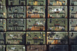 Tightly packed military ammo boxes with assorted rust patches