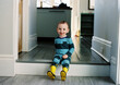© Cara Dolan/Stocksy - Portrait of Cute Happy Toddler at Home Wearing Yellow Rubber Boots