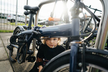 Little Boy Playing Near Bicycles