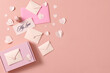 © Marc Tran/Stocksy - Gift with paper hearts on beige background with space for text