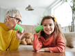 © Lumos sp - grandchild family child grandparent grandmother game playing granddaughter phone toy communication connection call string talk cup telephone voice message technology sound listen wire girl hobby