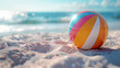 A colorful beachball on sandy beach