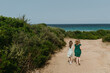 © Jovana Vukotic/Stocksy - Two friends walking towards beach