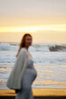© Iryna Shepetko/Stocksy - Pregnant woman  out of focus