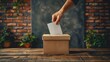 A person is placing a ballot into a wooden ballot box