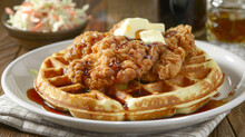 Classic American Dish Of Fried Chicken On Waffles With Syrup, Butter, And A Side Salad