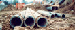 Pipes on ground prepared for use on building site closeup. Pipes integration in construction burgeoning framework ready to serve purpose.