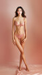 © Andrii - A youthful Asian female model exuding beauty and confidence while wearing a swimming suit on pink studio background.