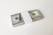 One hundred dollars bills. A ten thousand dollar bundle of new $100 bills on a white background.