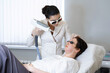 Aesthetician performs laser therapy, patient relaxed with goggles. Image taps into beauty trends and non-invasive skin treatments.