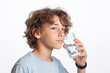 Handsome teenager enjoying a glass of pure water for good health and hydration.