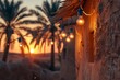 View of an old Saudi Arabian clay house in a village,, with small glowing bulbs strung above and several Arabian palm trees nearby, sunset in the background 